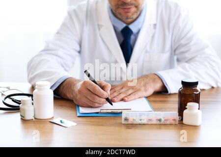 Close up of medical practitioner writing prescription Stock Photo