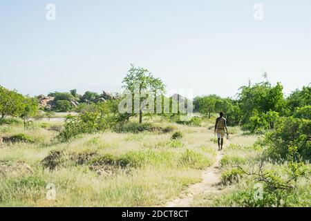 Hadzabe hunter hunts in the bush near his village Stock Photo