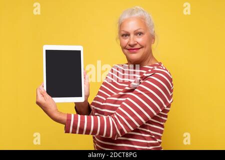 hispanic woman displaying a blank white laptop screen to the camera Stock Photo