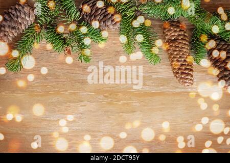 Christmas template with fir branches, cones and blurres lights Stock Photo