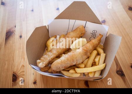 freshly cooked high quality fish and chips porthminster beach cafe takeaway box on wood table Stock Photo