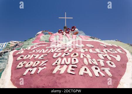 General view of Salvation Mountain in Niland, CA, USA in 2017. The artwork is made from adobe, straw and thousands of gallons of lead-free paint. Salvation Mountain was created by local resident Leonard Knight (1931–2014). It encompasses numerous murals and areas painted with Christian sayings and Bible verses, though its philosophy was built around the Sinner’s Prayer. The Folk Art Society of America declared it 'a folk art site worthy of preservation and protection' in the year 2000. In an address to the US Congress on May 15, 2002, California Senator Barbara Boxer described it as 'a unique Stock Photo