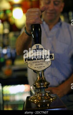 A barman pulling a pint in a pub ,St Just ,Cornwall , UK Stock Photo