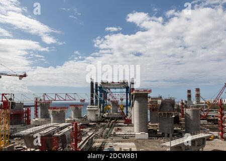 NO WEB/NO APPS - Exclusive. Precast concrete columns and voussoirs for the viaduct are produced at the construction site of the New Coastal Highway (Nouvelle Route du Litttoral), in La Reunion Island, France in October 2017. The new 12.3 km offshore highway will connect Saint-Denis, the island’s administrative capital, with La Possession and replace the existing cliff road subject to rock falls and flooding during tropical storms. It will have three lanes in each direction and improve transport when complete in 2018. It will be the most expensive road/km funded in France with a cost at 1.6 bil Stock Photo