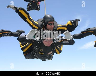 Former United States President George H.W. Bush jumps with the United States Army Golden Knights Parachute Team at the Bush Presidential Library near Houston, Texas on June 13, 2004 to celebrate his his 80th birthday. His jump was witnessed by 4,000 people including Actor and martial-arts expert Chuck Norris and Fox News Washington commentator Brit Hume. Both also participated in celebrity tandem jumps as part of the event. Bush made the jump harnessed to Staff Sergeant Bryan Schell of the Golden Knights. Bush was reportedly contemplating a free-fall jump, but officials said the wind condition Stock Photo