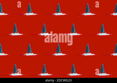 Christmas Pattern made Snowy Christmas Tree with Snow on Red Background. Minimal New Year concept. Flat lay. Stock Photo