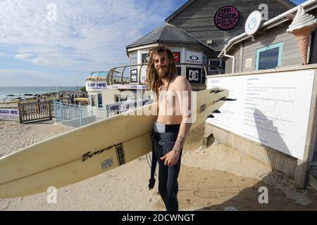 Portrait of happy Surfer with dreadlocks and surfboard at Fistral Beach in Newquay , Cornwall, England Stock Photo