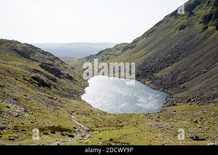 Goat's Water viewed from Goat's Hawse on the path between The Old Man of Coniston and Dow Crag the Lake District Cumbria England Stock Photo