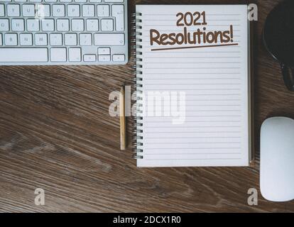 A desk with a notebook and computer with the business planning for the future and 2021 resolutions Stock Photo