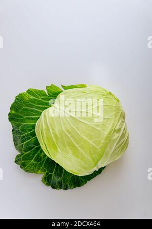 Whole cabbage isolated on a white background. Produce product. Vertical photo. Stock Photo