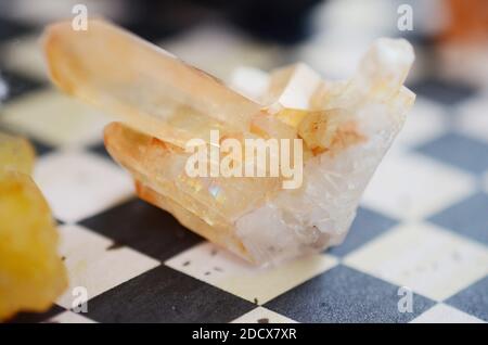 Beautiful quartz cluster, tangerine quartz. Orange healing crystal on display, bohemian vibes, minimalism witchcraft. Small crystal cluster, natural. Stock Photo