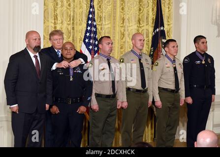 U.S. President Donald Trump presents the Public Safety Medal of Valor to (L-R) District Attorney Investigator Chad Johnson, San Bernardino County District Attorney's Office, CA; Detective Brian Olvera, San Bernardino Police Department, CA; Deputy Shaun Wallen, San Bernardino County Sheriff's Department, CA; Detective Bruce Southworth, San Bernardino County Sheriff's Department, CA; Corporal Rafael Ixco, San Bernardino County Sheriff's Department, CA; during an award ceremony at the East Room of the White House February 20, 2018 in Washington, DC. Photo by Olivier Douliery/Abaca Press Stock Photo