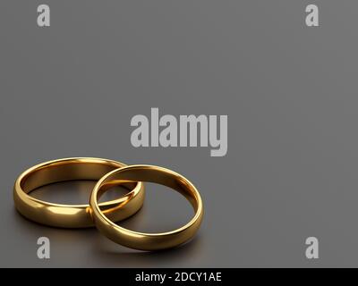 Two wedding gold rings lie next to each other on grey background. 3d rendering Stock Photo