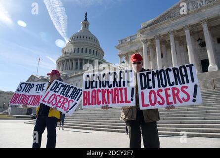 Trump supporters hold signs in front of the U.S Capitol ,January 20, 2018, after a short-term spending bill vote failed Friday night, sending the government into a shutdown on the one-year anniversary of President Trump's inauguration in Washington, DC. Photo by Olivier Douliery/Abaca Press Stock Photo