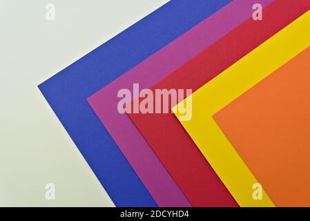Blue, purple, red, yellow and orange sheets of cardboard paper for arts and crafts projects. isolated on white. Stock Photo