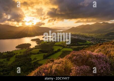 Sun setting behind moody clouds with dramatic evening light in the English Lake District. Stock Photo