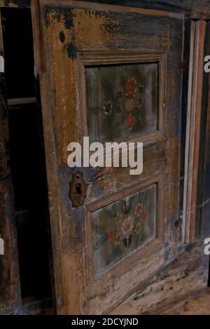 Medieval wooden door with rusted iron door knob. Wood is in yellow golden color. Stock Photo