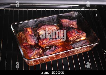 Roasted pork in a glass container. Close up. Stock Photo