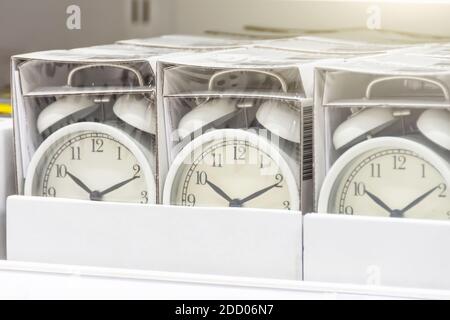 Lots of new alarm clocks in a box on a store shelf Stock Photo