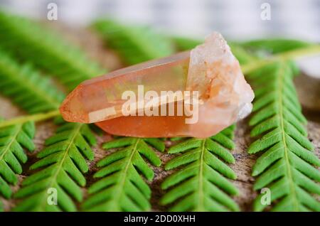 Beautiful quartz cluster, tangerine quartz. Orange healing crystal on display, bohemian vibes, minimalism witchcraft. Small crystal cluster, natural. Stock Photo