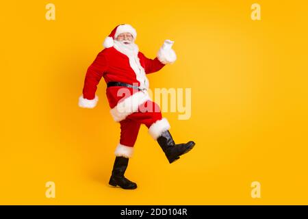 Full length body size view of his he nice funny cheerful cheery thick white-haired Santa St Nicholas walking having fun isolated bright vivid shine Stock Photo