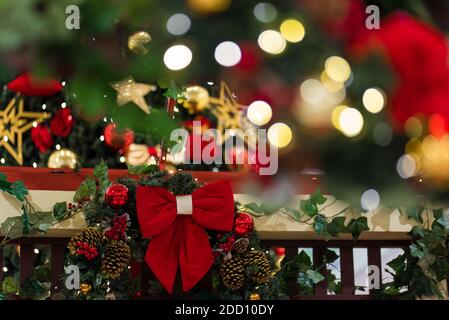 Decorative Christmas Wreath With Red Bow and Blurred Lights Background Stock Photo