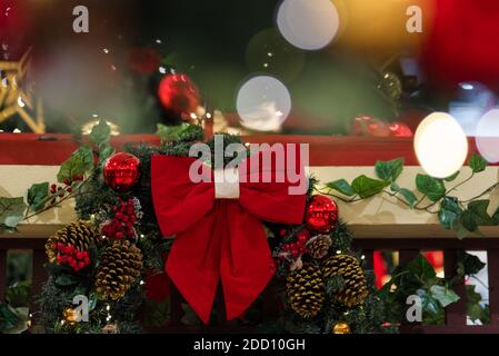 Decorative Christmas Wreath With Red Bow and Blurred Lights Background Stock Photo
