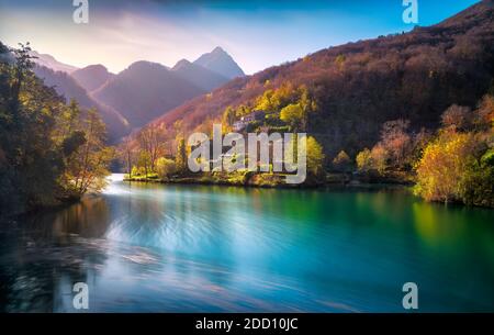 Isola Santa medieval village, lake and Alpi Apuane mountains in autumn foliage. Garfagnana, Tuscany, Italy Europe. Long exposure. Stock Photo