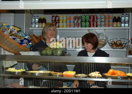 Two English ladies, serving in sandwich bar in the Buttermarket, Chichester West Sussex  England.  Model Release Stock Photo