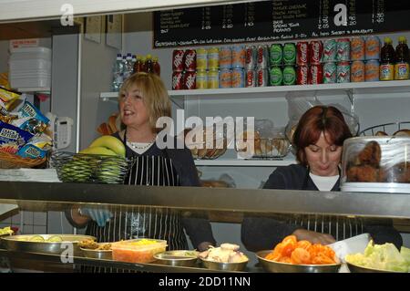 Two English ladies serving in sandwich bar in the Buttermarket, Chihchester, West Sussex England.  Model Release Stock Photo