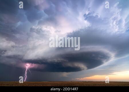 Supercell thunderstorm with lightning and dramatic storm clouds near Sublette, Kansas Stock Photo