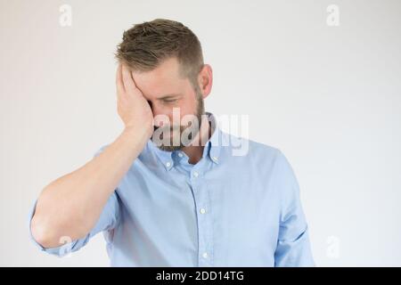 Handsome young man having headache. Isolated over white background. Stock Photo