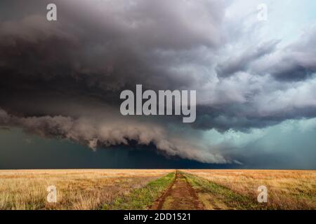 A severe thunderstorm with dark clouds and stormy sky over a field in Kansas Stock Photo