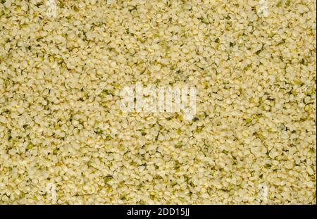 Hulled hemp seeds. Surface and background of raw and edible hempseeds.  Cannabis sativa, high in complete protein and a great source of iron. Stock Photo