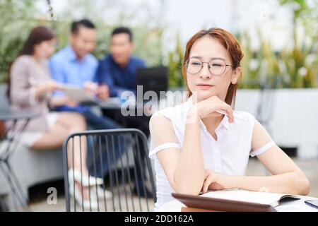 Pensive Vietnamese businesswoman Stock Photo