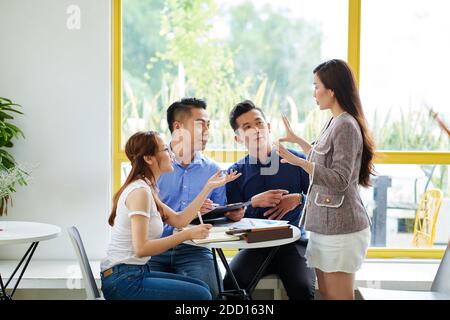 Young entreprneurs gathered in cafe Stock Photo