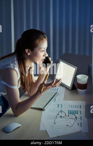 Female developer talking on phone Stock Photo