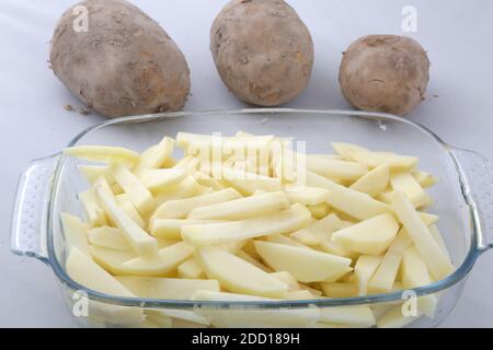 raw sliced potatoes ready to fried as side dish Stock Photo