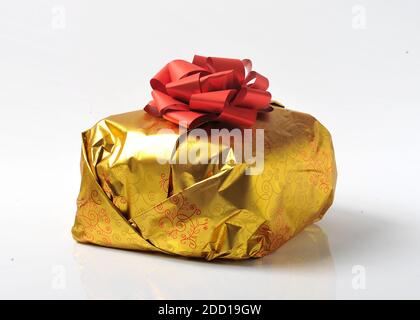 christmas panettone cake isolated on white background in its own gold-colored packaging Stock Photo