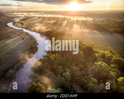 sunrise aerial drone landscape of river in green field, top view of beautiful nature texture from drone