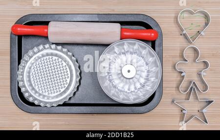 Children's baking set with rolling pin, muffin and cookie tins. Stock Photo
