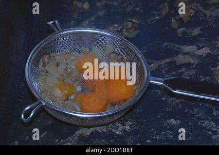 percolation of different vegetables in the metal colander Stock Photo