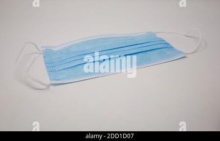 Regular Blue Mask blue disposable face mask isolated on white background Stock Photo - Alamy