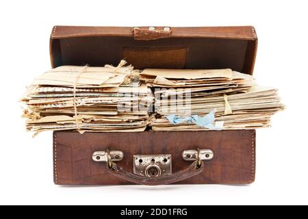 Bunches of paper mails of 20 century in the vintage suitcase, isolated on white Stock Photo