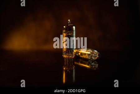 Guitar amplifier tube isolated closeup in dark space Stock Photo