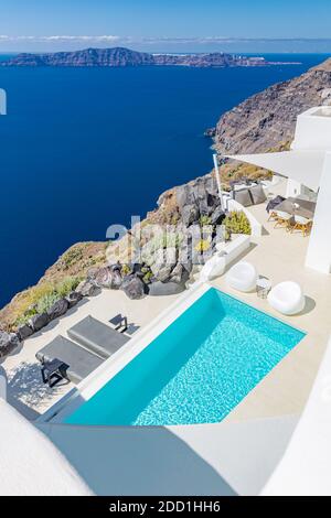 Luxury hotel resort and empty infinity swimming pool Santorini. Summer vacation travel destination romantic couple holiday. Sea caldera view landscape