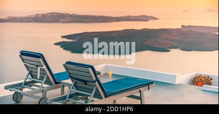 Infinity pool on the rooftop at sunset in Santorini Island, Greece. Beautiful poolside and sunset sky. Luxurious summer vacation and holiday concept, Stock Photo