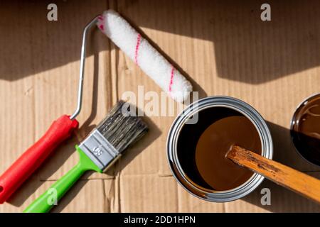 paint roller in tray, brushes, and paint can.decorating and house renovation tools. painter and decorator working table.Painting tools and accessories Stock Photo