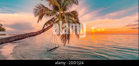 Tropical beach sunset as summer landscape with luxury resort beach swing, calm sea for sunset beach landscape. Tranquil beach scenery summer vacation Stock Photo