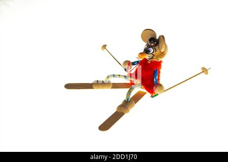isolated white background: a figurine of a mouse on skis. Stock Photo